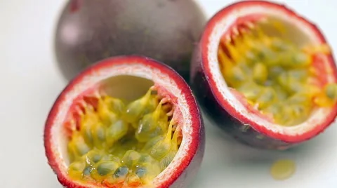 Halved Passion Fruit on white background Stock Footage