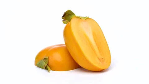 Halved Persimmon Rotating Against a White Background Video stock 345010452