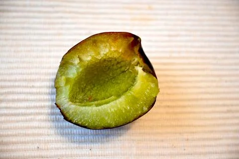 Halved plum on a textured background Stock-Fotos