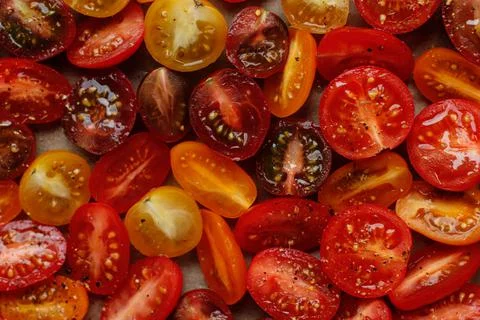 Halved red and yellow cherry tomatoes pattern. mix of fresh and juicy vegetab Stock Photos