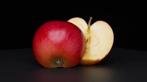 Halved Red Apple Rotating on black Background Stock-Footage 346474671