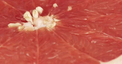 Halved red pomelo fruit closeup rotating Stock Footage 199090431