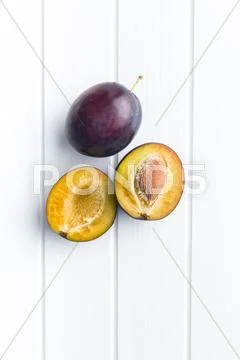 Halved ripe plums. Stock Photos