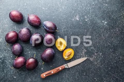 Halved ripe plums. Stock Photos