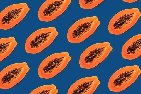 Halves of apaya on a blue backgraund, pattern Stock Photos