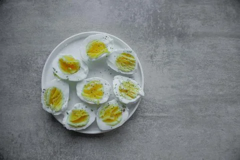 Halves of a boiled eggs on a plate with space for text Stock Photos