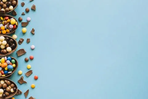 Halves chocolate eggs with sweets Stock Photos