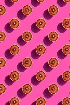 Halves of oranges on a pink background Stock Photos