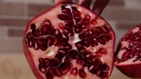 Halves of Pomegranate Displayed by Woman's Hands 스톡 동영상 222473023