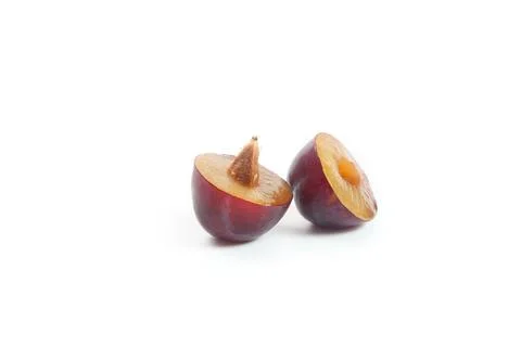 Halves purple plum isolated on white background. . Stock Photos