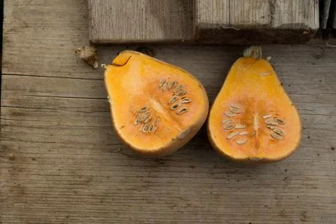 Halves of a Squash on Wooden Surface Stock Photos