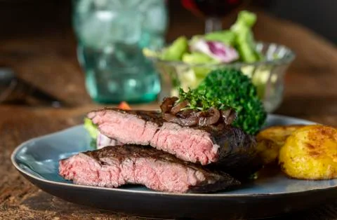 Halves of a steak on a plate Stock Photos