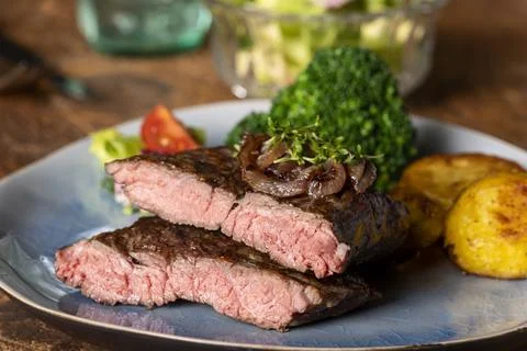 Halves of a steak on a plate Stock Photos