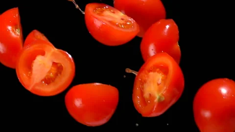 Halves of tomatoes with juice are falling down on Stock Footage 104406376