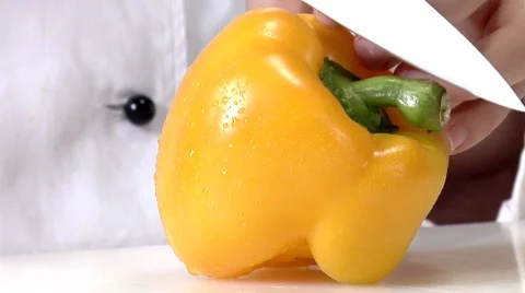 Halving and coring a yellow pepper Stock Footage 8573622