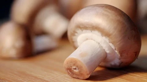 Halving a chestnut mushroom Stock Footage 8574304