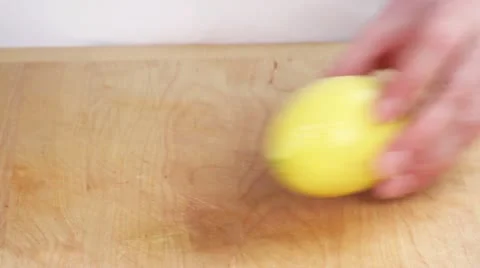 Halving a lemon Stock Footage 24655433