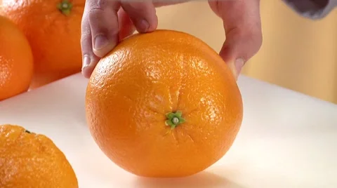 Halving an orange Stock-Footage 8573798