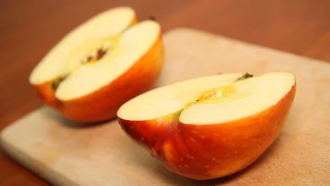 Halving a ripe apple in a kitchen. Stock Footage 127321715