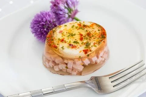 Ham and egg in aspic on a plate Stock Photos