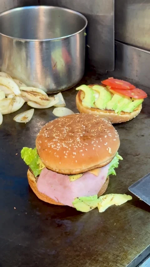 Ham and Lettuce Burger Assembled on Grill Station Stock Footage 323876150