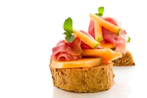 Ham and melon appetizer isolated Stock Photos