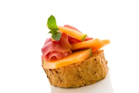 Ham and melon appetizer isolated Stock Photos