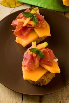 Ham and melon appetizer Stock Photos