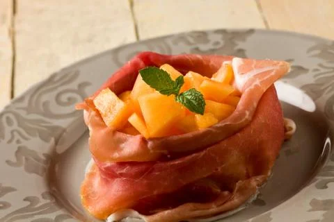 Ham and melon appetizer Stock Photos