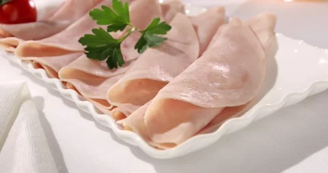 Ham with cherry tomato on a plate. meat delicacy on a light background. Stock Footage 242490963
