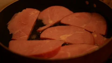 Ham cooking on a counter top for breakfast Stock Footage 308862453