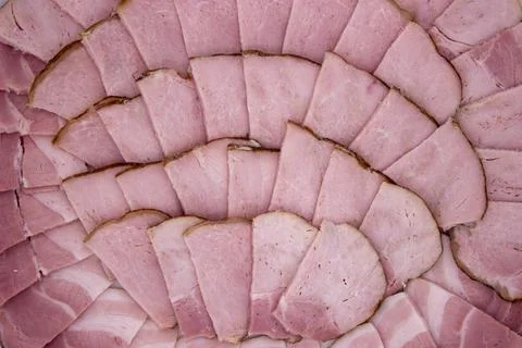 Ham cut into slices forms delicious background Stock Photos