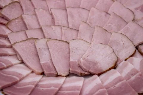 Ham cut into slices forms delicious background Stock Photos