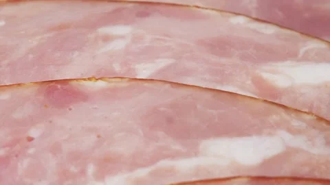 Ham cut into thin slices close-up. Sliced sausage is laid out in a semicircle Stock-Footage 219814886
