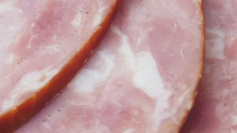 Ham cut into thin slices close-up. Sliced sausage is laid out in a semicircle Stock-Footage 219920256
