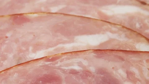 Ham cut into thin slices close-up. Sliced sausage is laid out in a semicircle Stock-Footage 221151282