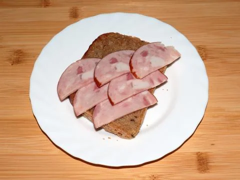 Ham on dark bread Stock Photos