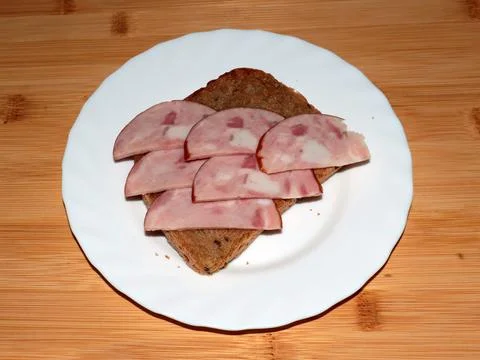 Ham on dark bread Stock Photos