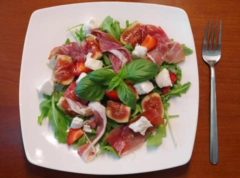 Ham with figs and rucola Stock Photos