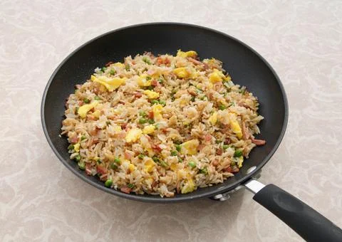 Ham fried rice in pan on table Stock Photos