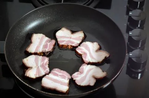 Ham in the frying pan Stock Photos