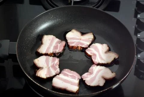 Ham in the frying pan Stock Photos