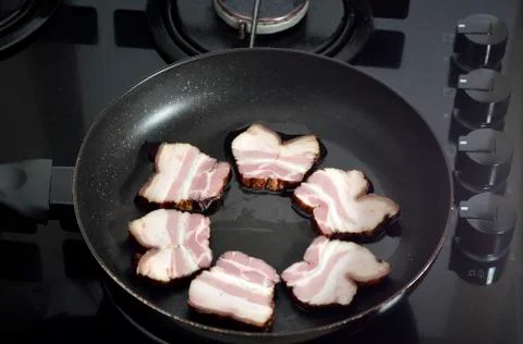 Ham in the frying pan Stock Photos