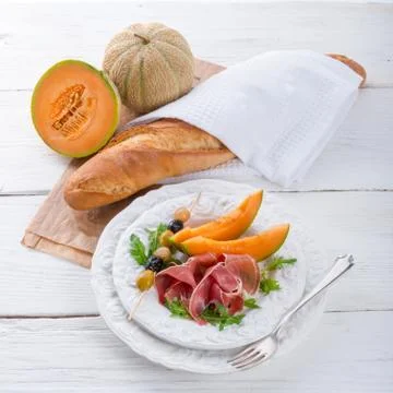 Ham with melon and olives Stock Photos