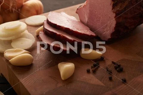 Ham, onion and garlic on the table Stock Photos