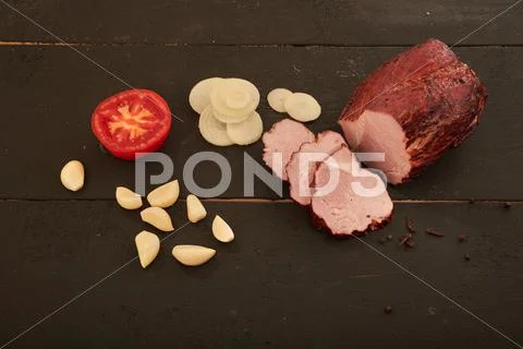 Ham, onion, garlic and tomatoes on the table Stock Photos