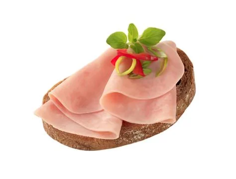 Ham slices on dark bread with garnish Stock Photos