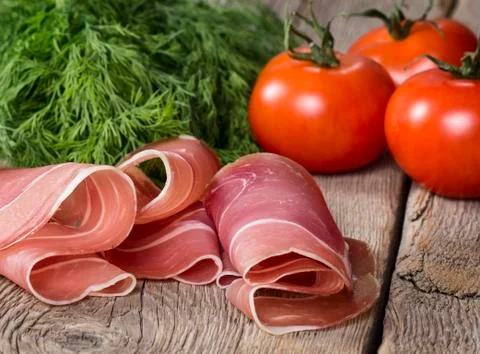 Ham with tomatoes and herb Stock Photos