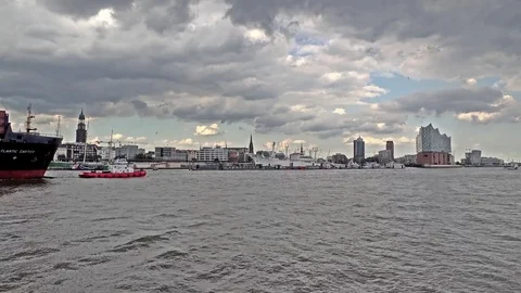 Hamburg / Germany - July 14, 2017: Huge container ship passing the river Elbe Stock Footage
