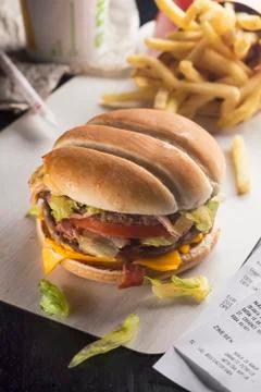 Hamburger and fried potatoes on the table. Fast food. Stock Photos
